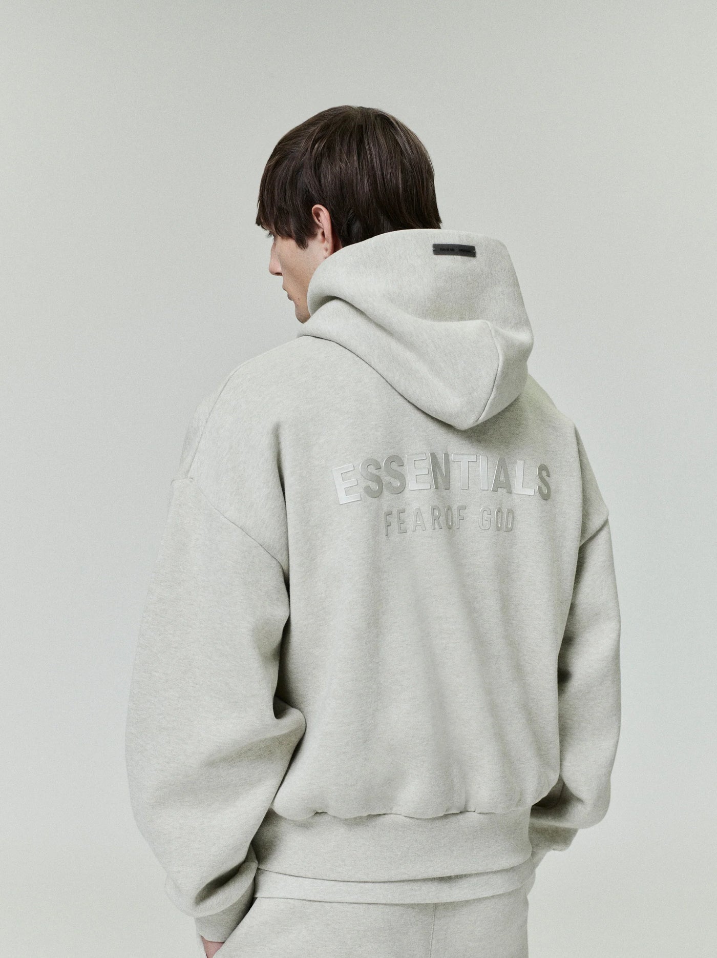 FEAR OF GOD ESSENTIALS Metallic Logo Fleece Hoodie ‘Heather Stone’ SP25